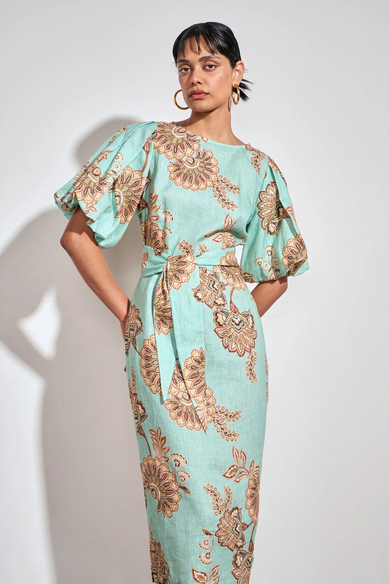 ZOE KRATSMANN COAST DRESS, A MIDI LENGTH MINT DRESS WITH A FLORAL PATTERN, PUFF SLEEVES AND A TIE AT THE WAIST