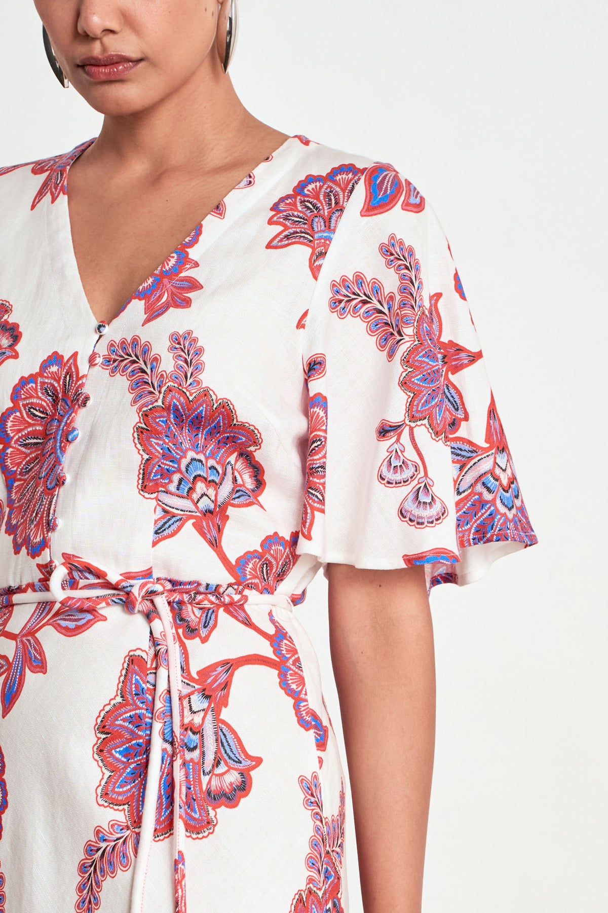 ZOE KRATZMANN PREMIER DRESS CRIMSON KGARI - A white midi dress with a vibrant pink and purple floral pattern.