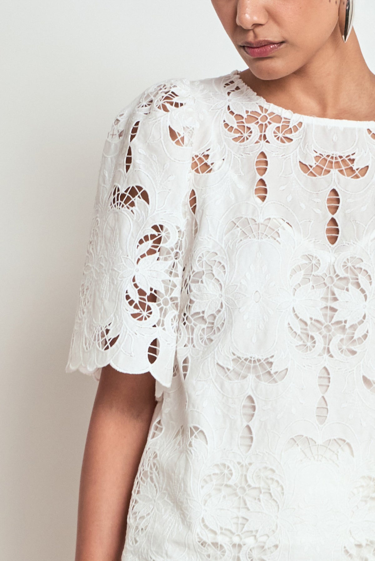ZOE KRATZMANN RESOLVE TOP white lace blouse with short flutter sleeves and a scalloped hem