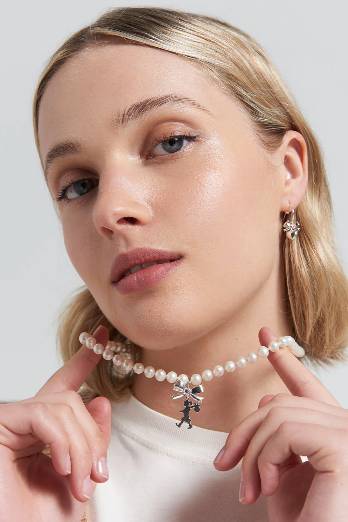 GIRL WITH BOW AND PEARLS NECKLACE