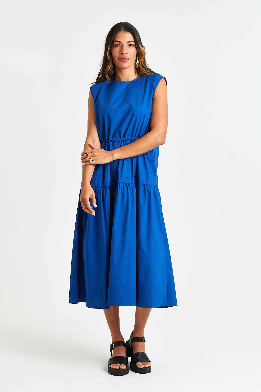 MARTINE DRESS Woman wearing a blue dress on a white background