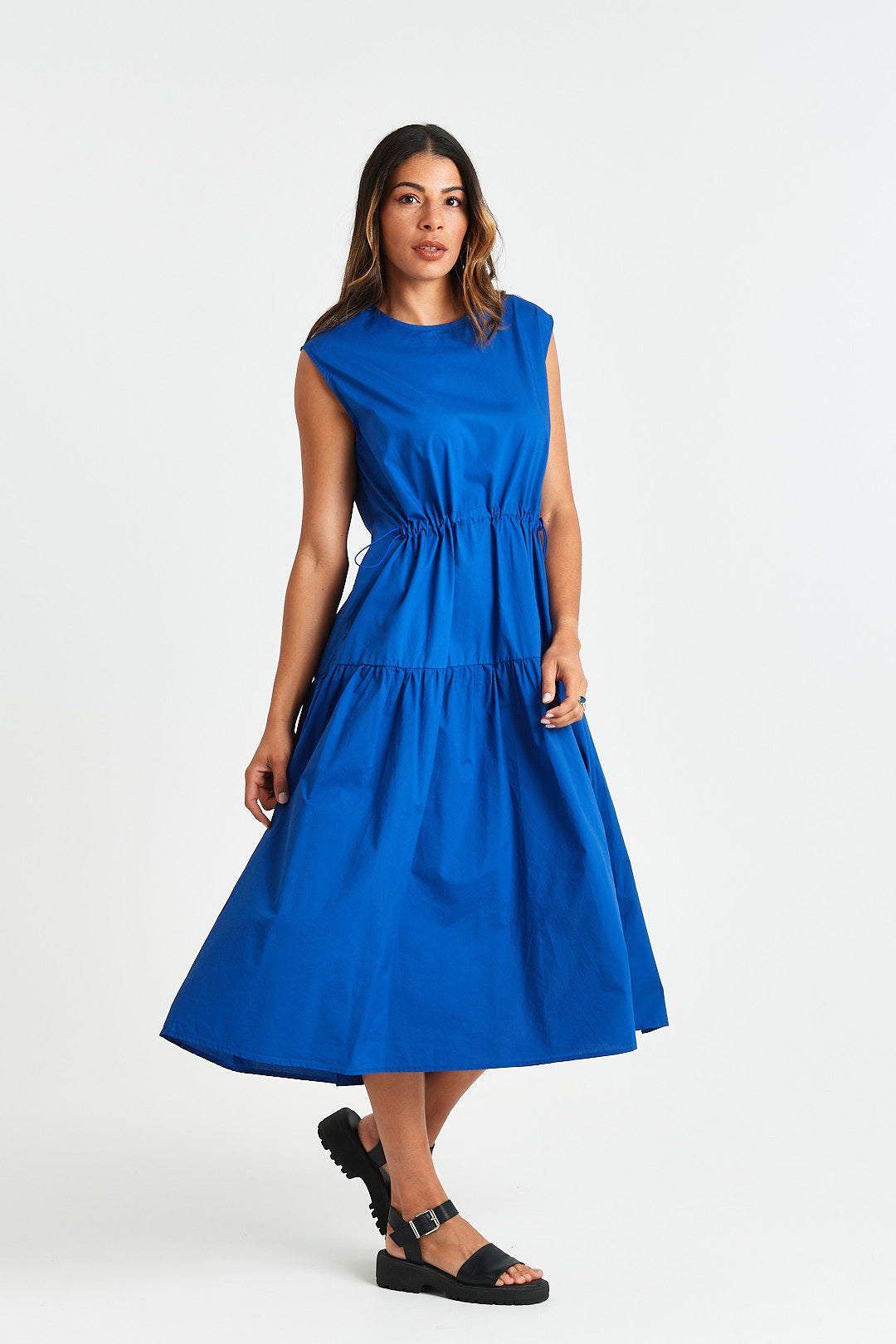 MARTINE DRESS Woman wearing a blue dress on a white background