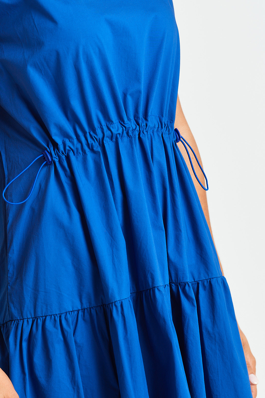 MARTINE DRESS Blue dress with a tie detail on a white background