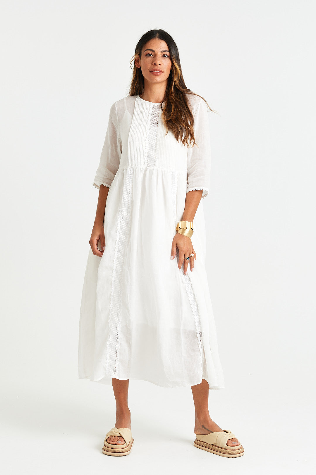 GISELLE DRESS Woman wearing a white dress on a white background