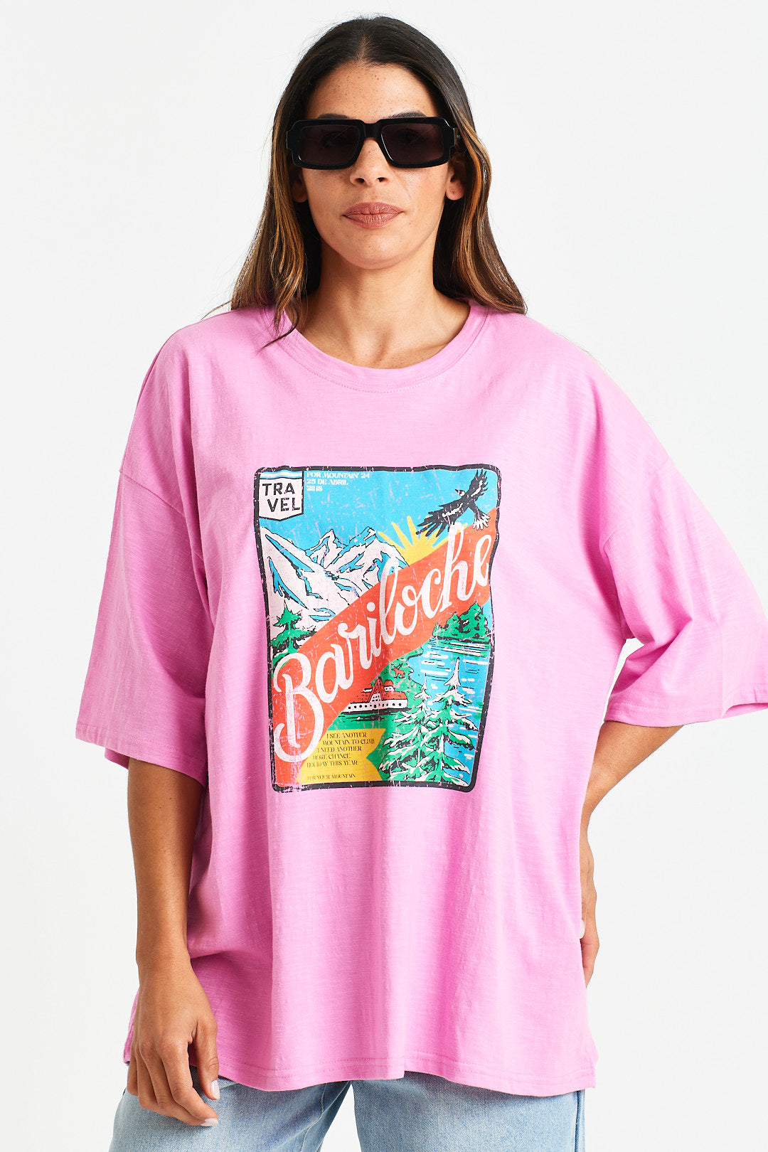 HENRI TEE Person wearing a pink t-shirt with a colorful graphic design on a white background