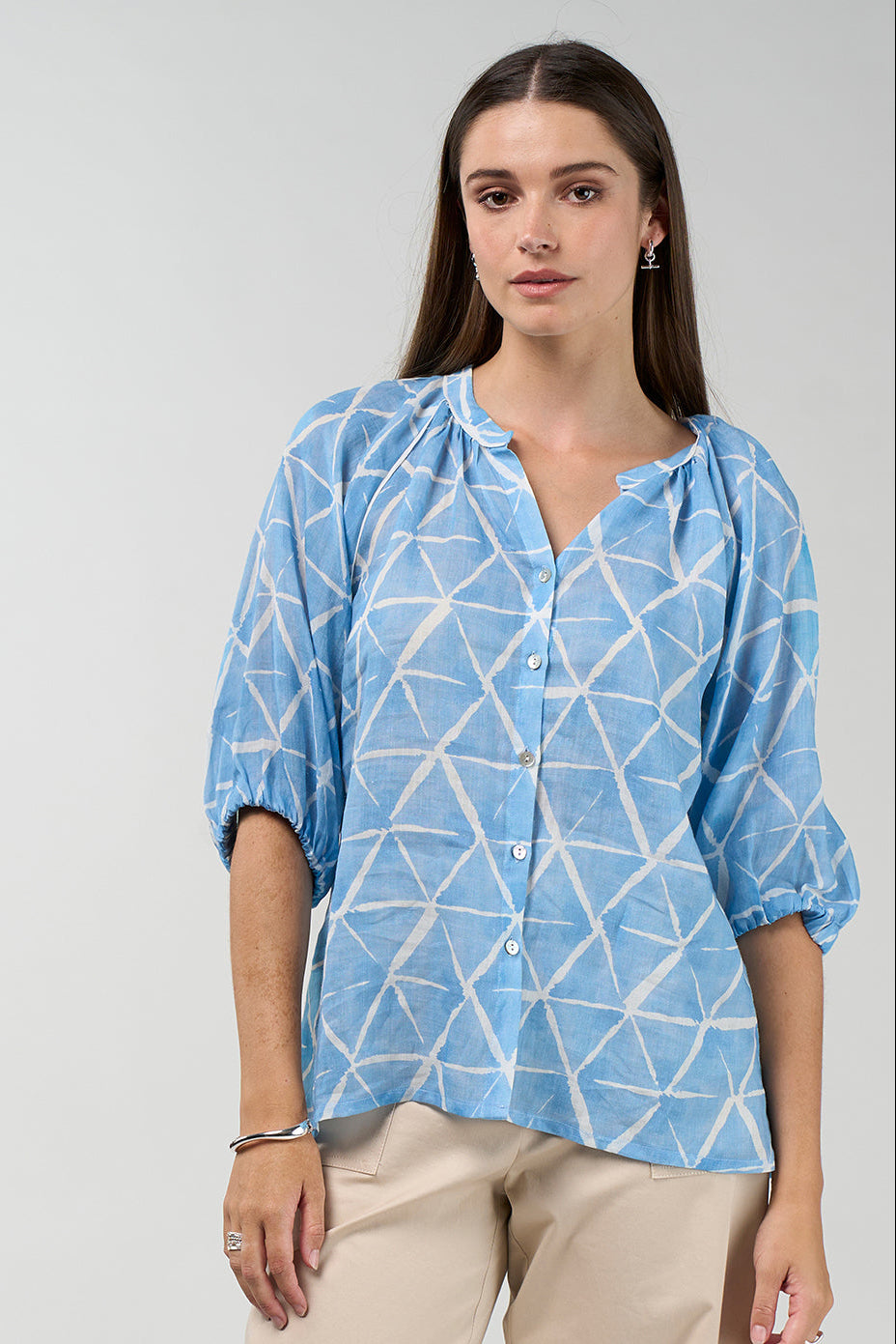 Prism button-down blouse in sky blue and white geometric print with gathered neckline and puff sleeves