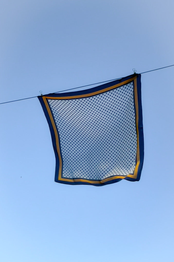 WENDYS SCARF SILK FEEL POLYESTER WHITE BASE WITH NAVY BLUE POLKA DOTS AND NAVY AND GOLD BOARDER