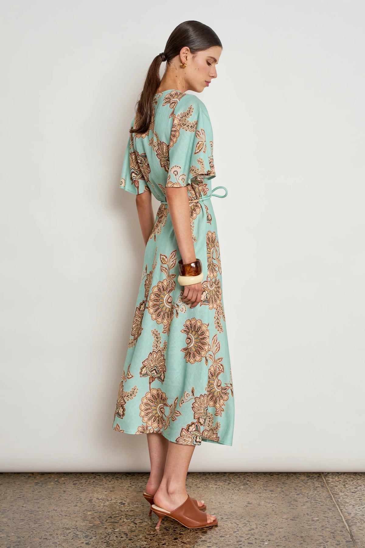 ZOE KRATSMANN PREMIER DRESS A MINT MAXI DRESS WITH A FLORAL PRINT, FLOATY SLEEVES, BUTTONS ALONG THE CLEAVAGE AND A TIE AT THE WAIST