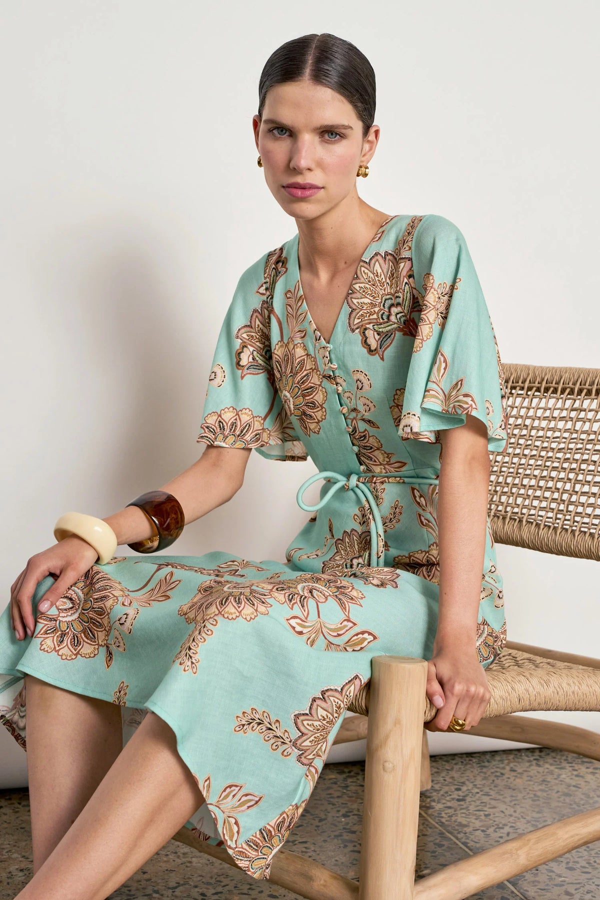 ZOE KRATSMANN PREMIER DRESS A MINT MAXI DRESS WITH A FLORAL PRINT, FLOATY SLEEVES, BUTTONS ALONG THE CLEAVAGE AND A TIE AT THE WAIST