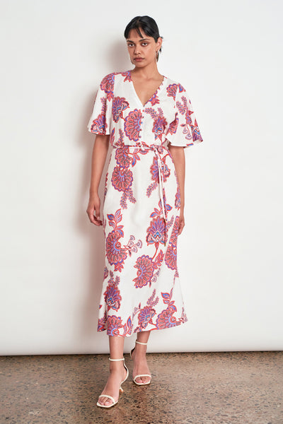 ZOE KRATZMANN PREMIER DRESS CRIMSON KGARI - A white midi dress with a vibrant pink and purple floral pattern.
