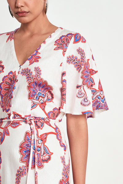 ZOE KRATZMANN PREMIER DRESS CRIMSON KGARI - A white midi dress with a vibrant pink and purple floral pattern.