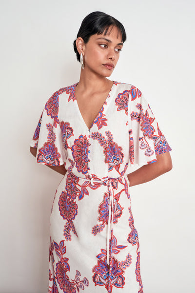 ZOE KRATZMANN PREMIER DRESS CRIMSON KGARI - A white midi dress with a vibrant pink and purple floral pattern.