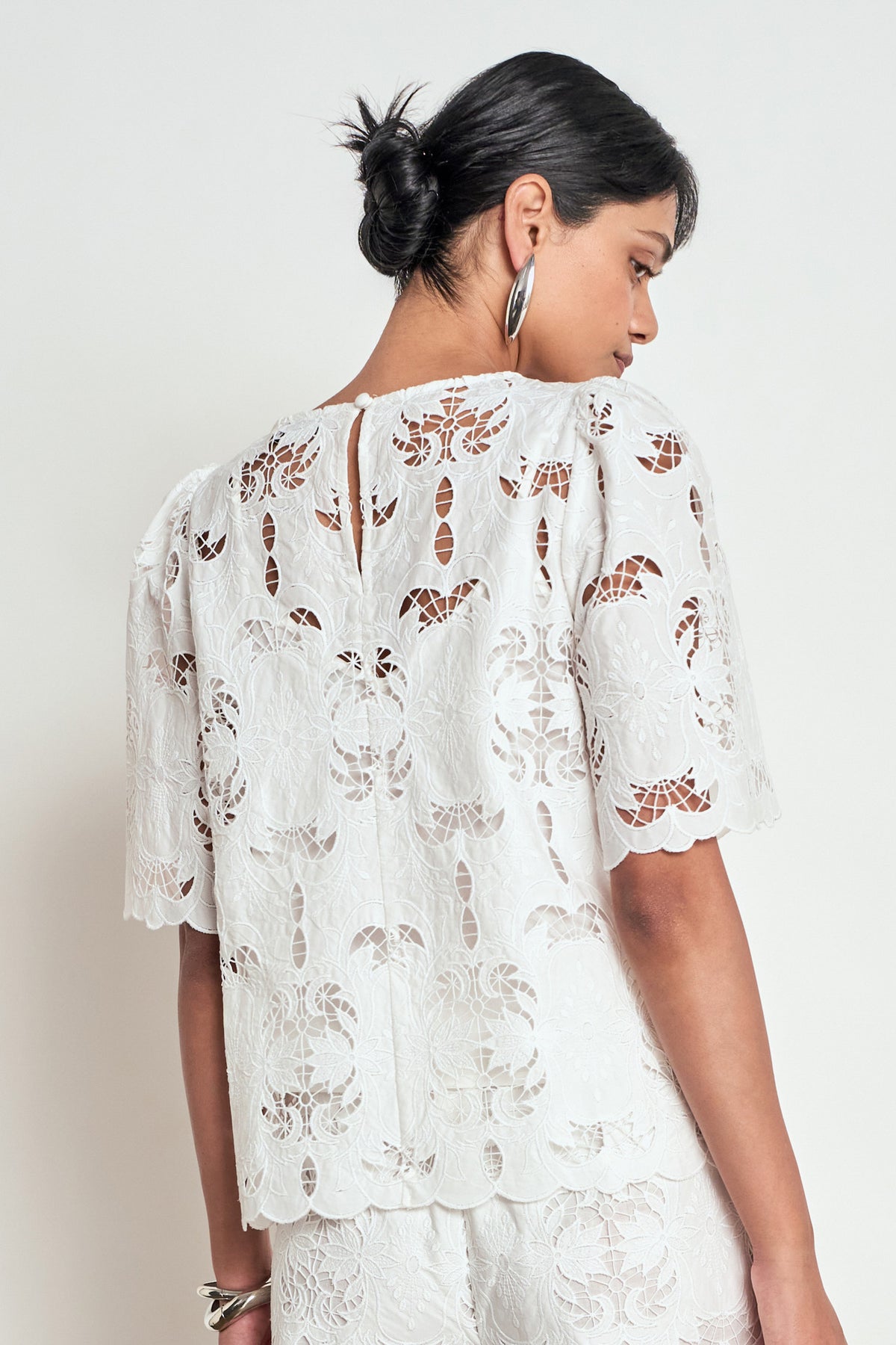 ZOE KRATZMANN RESOLVE TOP white lace blouse with short flutter sleeves and a scalloped hem