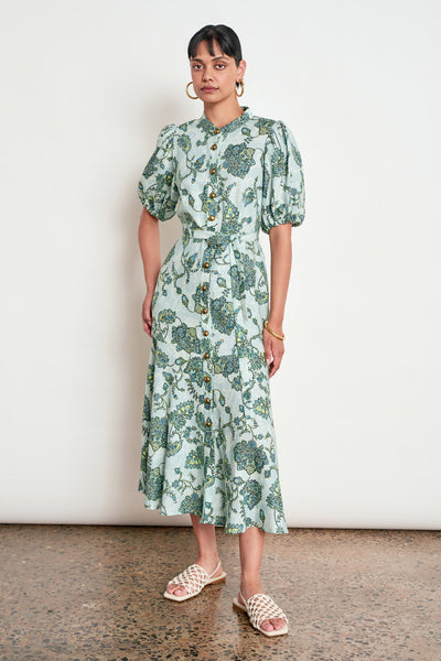 ZOE KRATZMANN CASCADE DRESS FERN PAISLEY - A light green midi dress with a blue and green floral print, featuring puff sleeves, a button-up front, and a tie-waist detail