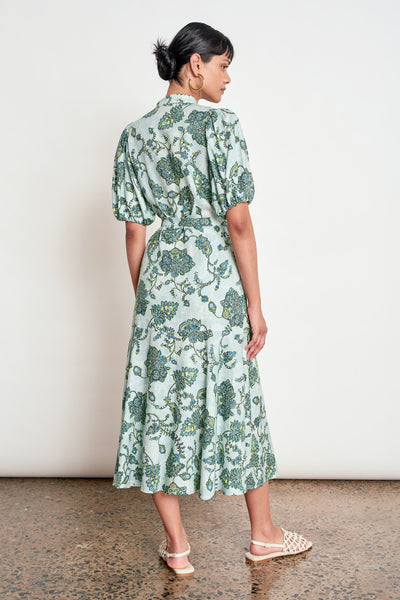 ZOE KRATZMANN CASCADE DRESS FERN PAISLEY - A light green midi dress with a blue and green floral print, featuring puff sleeves, a button-up front, and a tie-waist detail