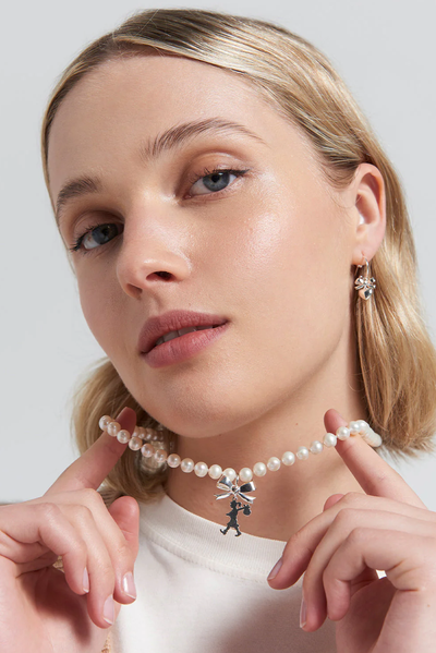 GIRL WITH BOW AND PEARLS NECKLACE