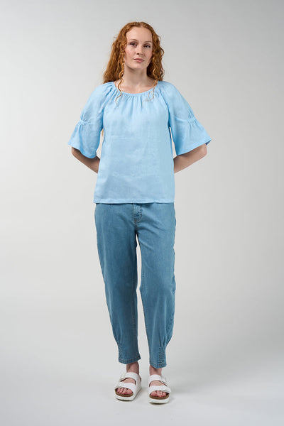 Cove linen blouse in sky blue with gathered round neckline and flared sleeves