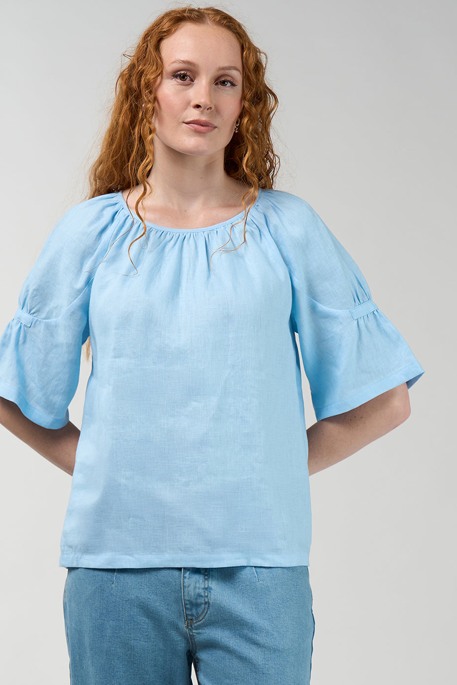Cove linen blouse in sky blue with gathered round neckline and flared sleeves