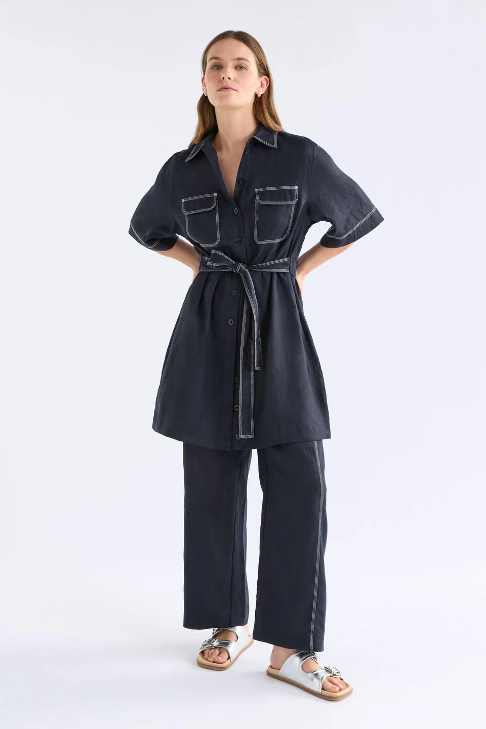ELK SONNEN DRESS NAVY LINEN MINI BUTTON UP SHIRT DRESS WITH WHITE CONTRAST STITCHING, ELASTIC WAIST ALONG THE BACK AND TIE AT THE WAIST ON THE FRONT PLUS TWO FRONT CHEST POCKETS 