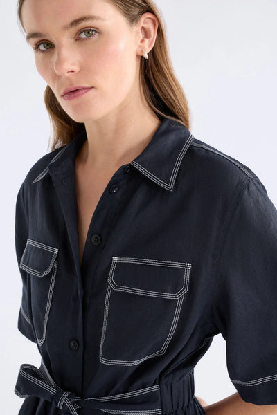 ELK SONNEN DRESS NAVY LINEN MINI BUTTON UP SHIRT DRESS WITH WHITE CONTRAST STITCHING, ELASTIC WAIST ALONG THE BACK AND TIE AT THE WAIST ON THE FRONT PLUS TWO FRONT CHEST POCKETS 