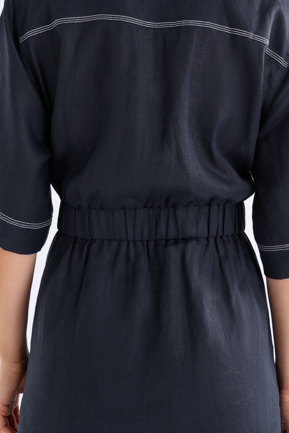 ELK SONNEN DRESS NAVY LINEN MINI BUTTON UP SHIRT DRESS WITH WHITE CONTRAST STITCHING, ELASTIC WAIST ALONG THE BACK AND TIE AT THE WAIST ON THE FRONT PLUS TWO FRONT CHEST POCKETS 