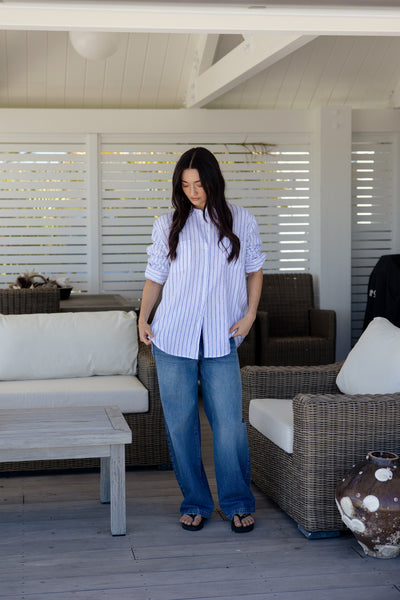 Womens white and blue vertically striped button-down shirt with pockets on the bust