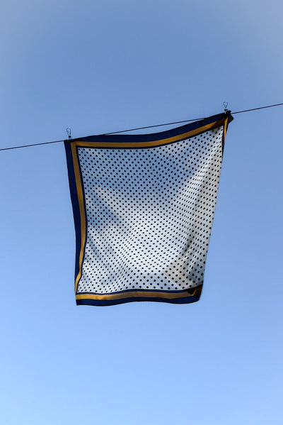 WENDYS SCARF SILK FEEL POLYESTER WHITE BASE WITH NAVY BLUE POLKA DOTS AND NAVY AND GOLD BOARDER