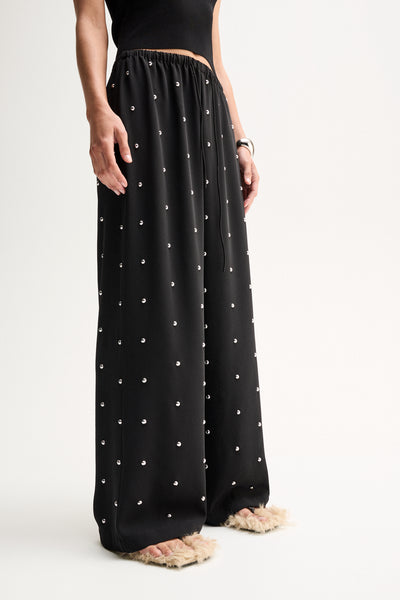 ELKA COLLECTIVE OLYMPIA PANT BLACK WIDE LEG PANTS BLACK WIDE LEG TROUSERS EMBELLISHED BLACK PANTS EMBELLISHED TROUSERS STUDDED BLACK PANTS RHINESTONE PANTS CRYSTAL EMBELLISHED TROUSERS BLACK FLOWY PANTS RELAXED FIT TROUSERS WIDE LEG TROUSERS WOMEN HIGH WAISTED BLACK PANTS ELASTICATED WAIST PANTS DRAWSTRING TROUSERS STATEMENT TROUSERS EVENING TROUSERS ELEGANT BLACK PANTS LUXURY BLACK TROUSERS WOMEN'S DESIGNER TROUSERS CONTEMPORARY WOMEN'S FASHION CHIC BLACK TROUSERS DRESSY WIDE LEG PANTS BLACK STATEMENT PANT